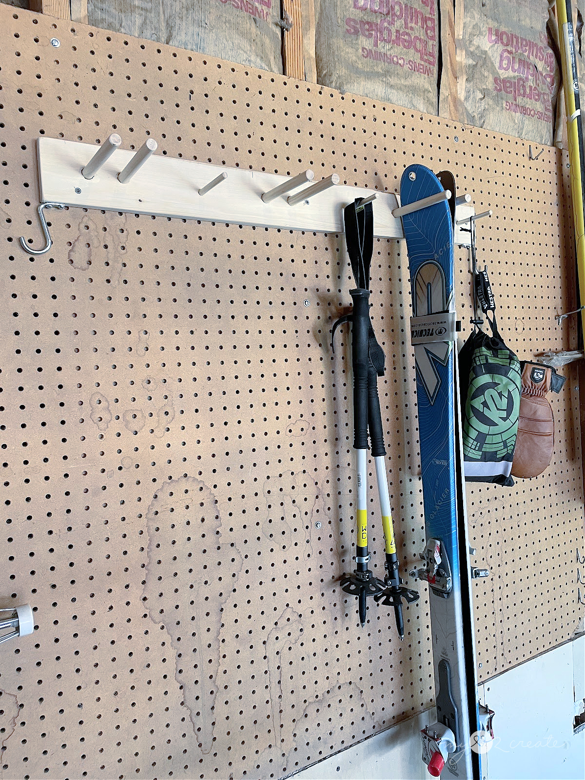 hanging skis and accessories on a custom ski rack