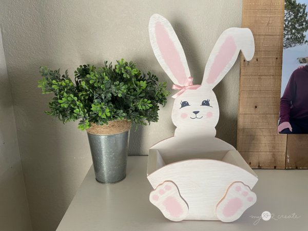 This adorable wooden Easter Bunny crate is a charming DIY project perfect for festive decor or as a creative gift basket. Handcrafted and painted with delicate pastel tones, it features a smiling bunny face and a spacious hexagonal crate for holding Easter treats. The rustic yet playful design makes it a delightful addition to any Easter celebration, embodying the creative spirit of "My Love 2 Create."