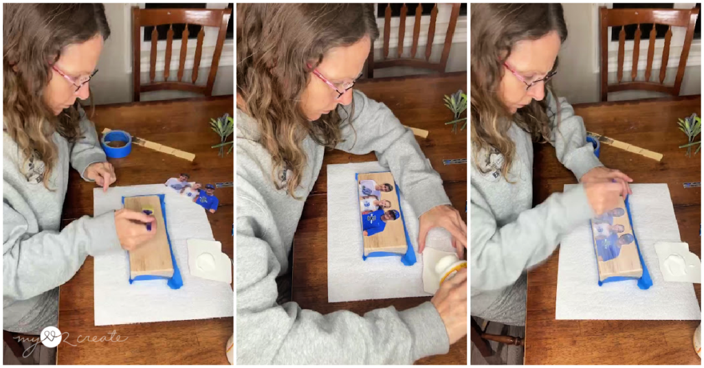 Woman applying Mod Podge to a printed photo on a wooden board in a step-by-step DIY project.